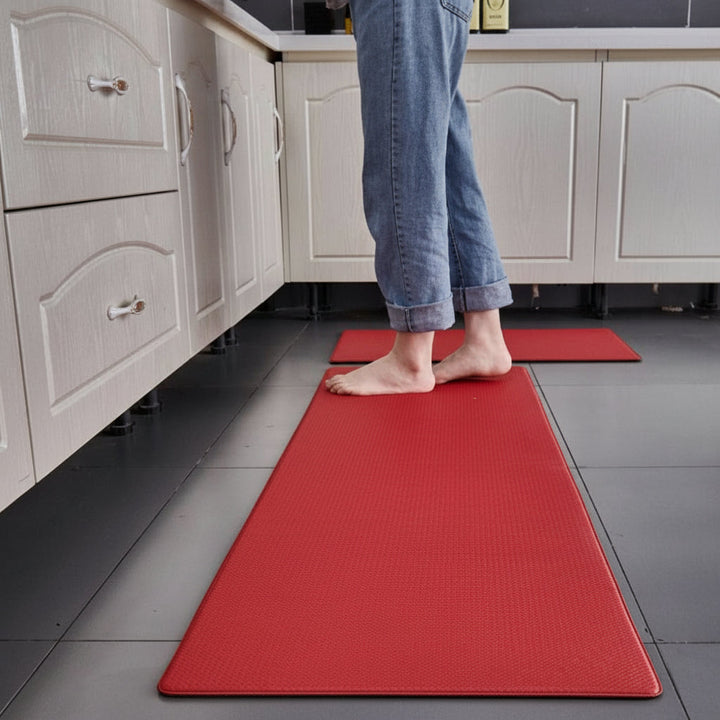 Ergonomic anti-fatigue kitchen mat in a modern home kitchen, providing standing comfort & support.
