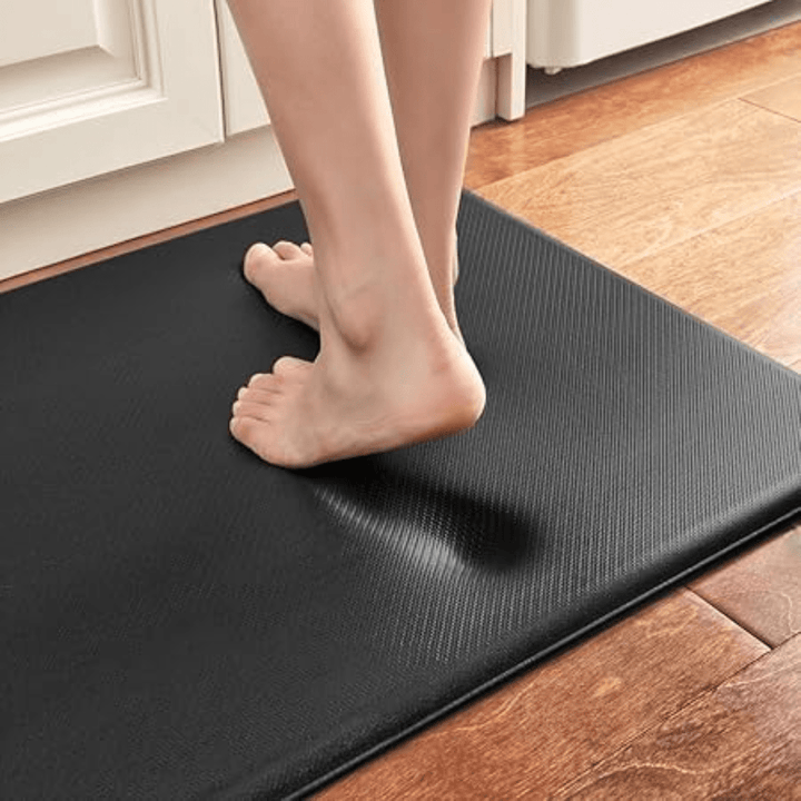 Anti-fatigue kitchen mat placed under a kitchen sink, offering ergonomic support & comfort while standing.