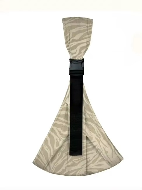 Parent wearing ergonomic baby hip carrier with baby on hip, wide shoulder strap visible