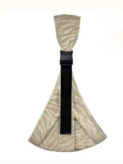 Parent wearing ergonomic baby hip carrier with baby on hip, wide shoulder strap visible