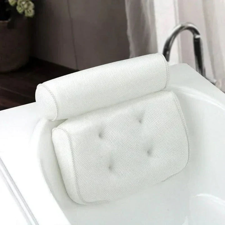 White ergonomic bath cushion with strong suction cups, providing head & neck support for a luxury spa bath experience.