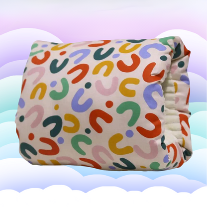 White ergonomic nursing pillow with grey trim, providing gentle support for baby during feeding