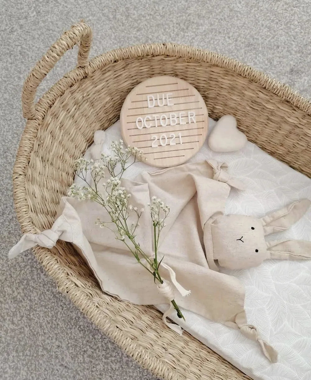 Detailed shot of a baby's hand near the oak milestone board, a lovely newborn prop.