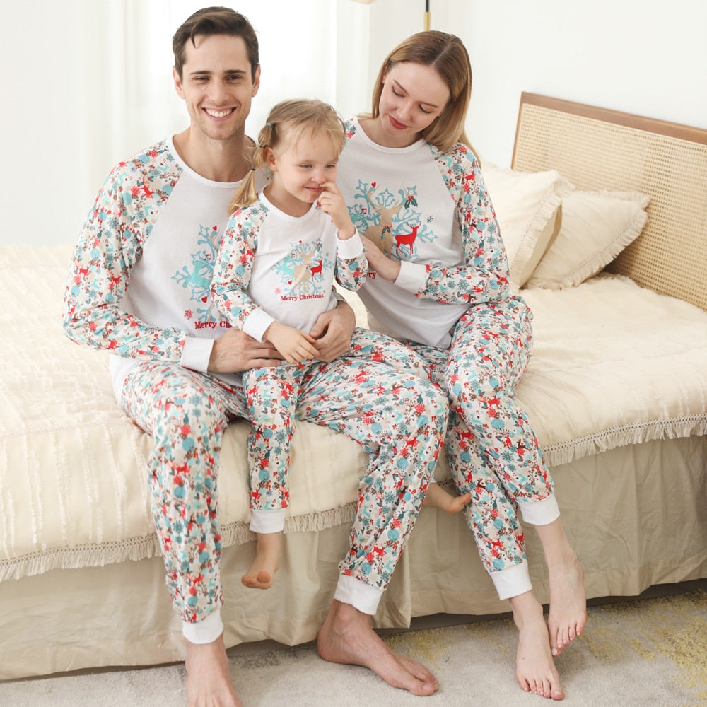 Matching family Christmas pajamas set with festive pattern, long sleeve tops and pants for holiday comfort