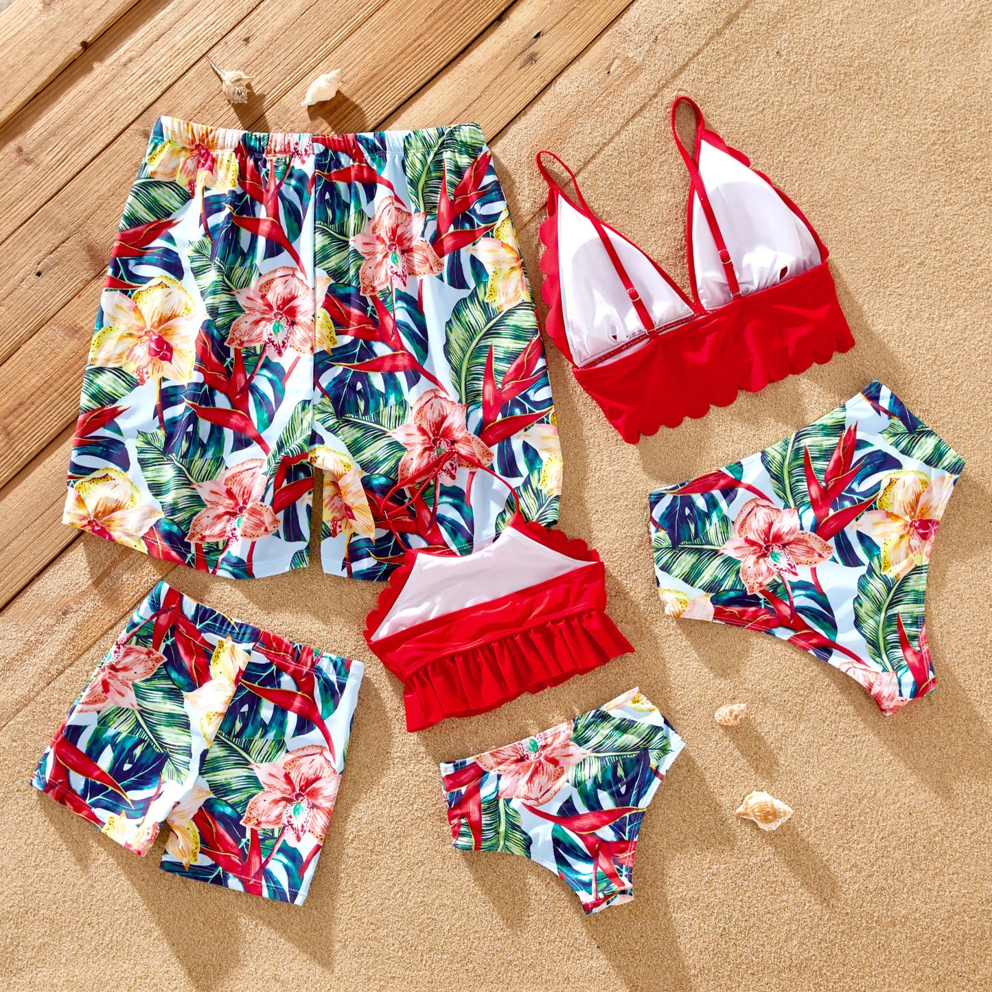 Family of four wearing matching floral swim trunks and one-piece swimsuits, beachwear.