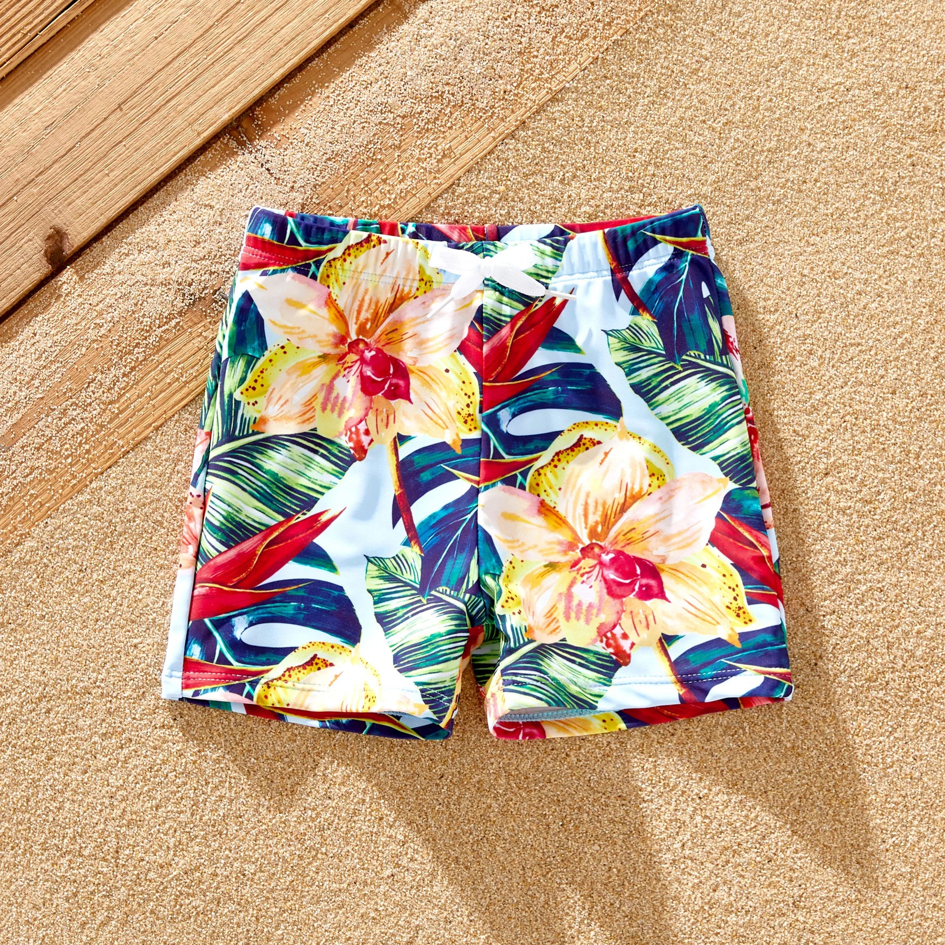 Close-up of pink floral print on a family matching swimwear set, summer outfits.