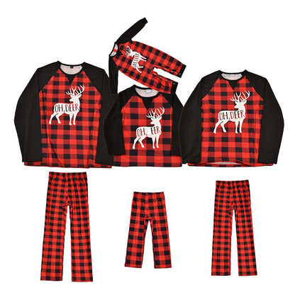 Close-up of a child in red plaid reindeer Christmas pajamas, cozy and cute for holidays