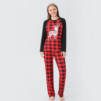 Pet dog wearing a matching plaid reindeer pajama, joining the family Christmas sleepwear