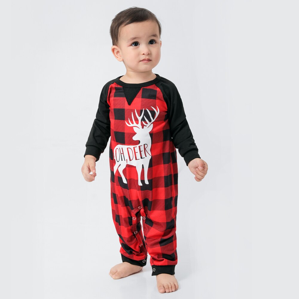 Detail of the red and black plaid fabric with a reindeer motif on Christmas pajamas