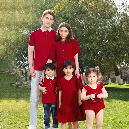 Close-up of a baby wearing a red cotton romper, part of a family matching outfit set