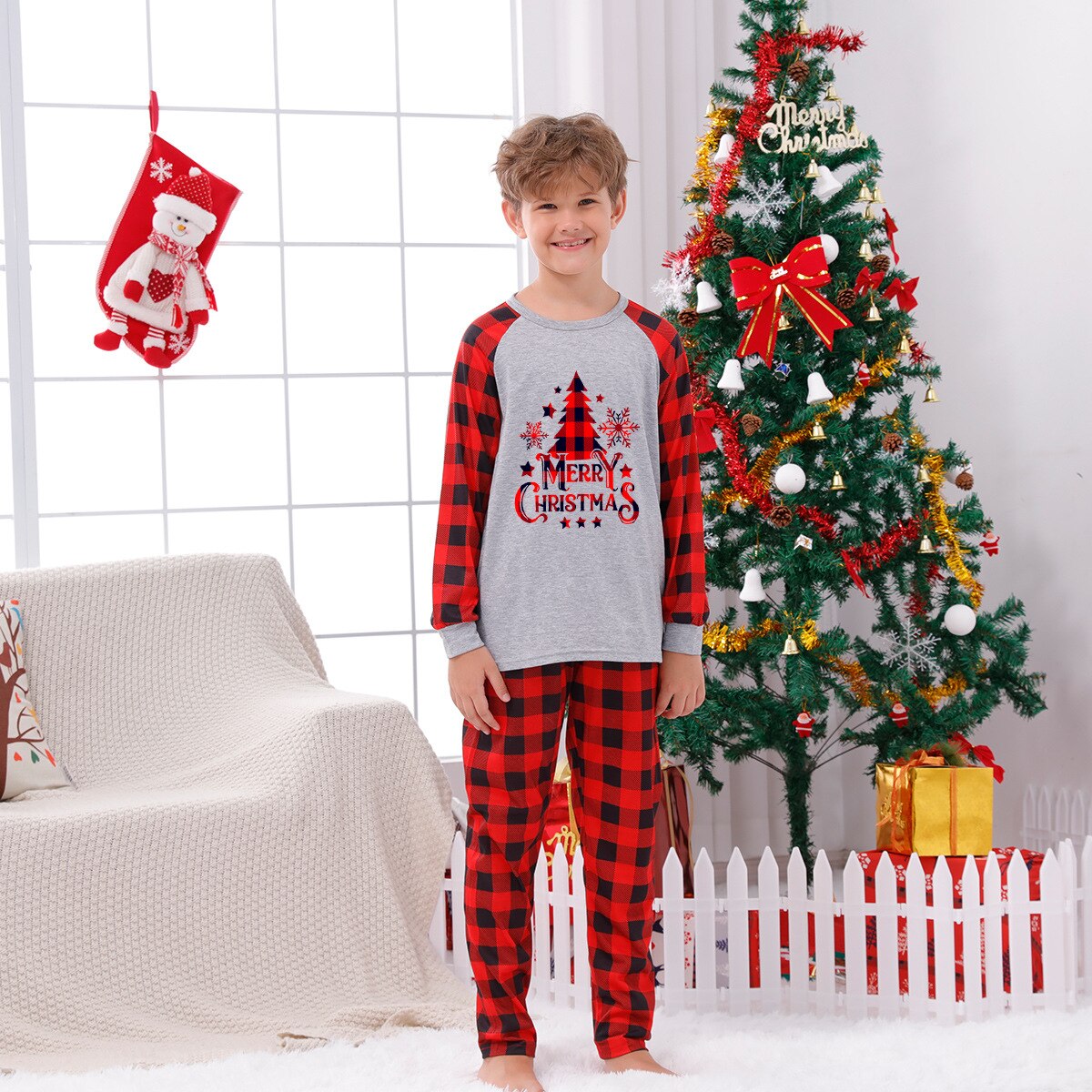 Father and son in matching red plaid Christmas pajamas, enjoying holiday sleepwear together.