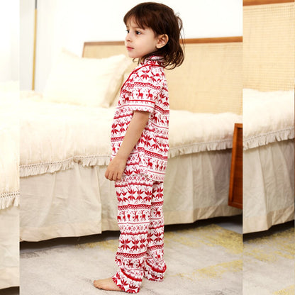 Baby wearing a cute red short-sleeve polyester holiday pajama set, comfortable for sleep