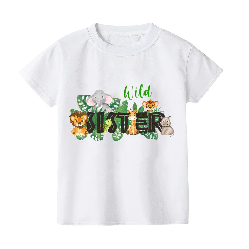 Adorable baby wearing a wild print romper, matching with family's t-shirts for summer.