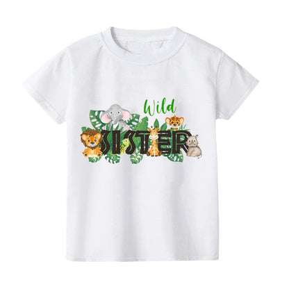 Adorable baby wearing a wild print romper, matching with family's t-shirts for summer.