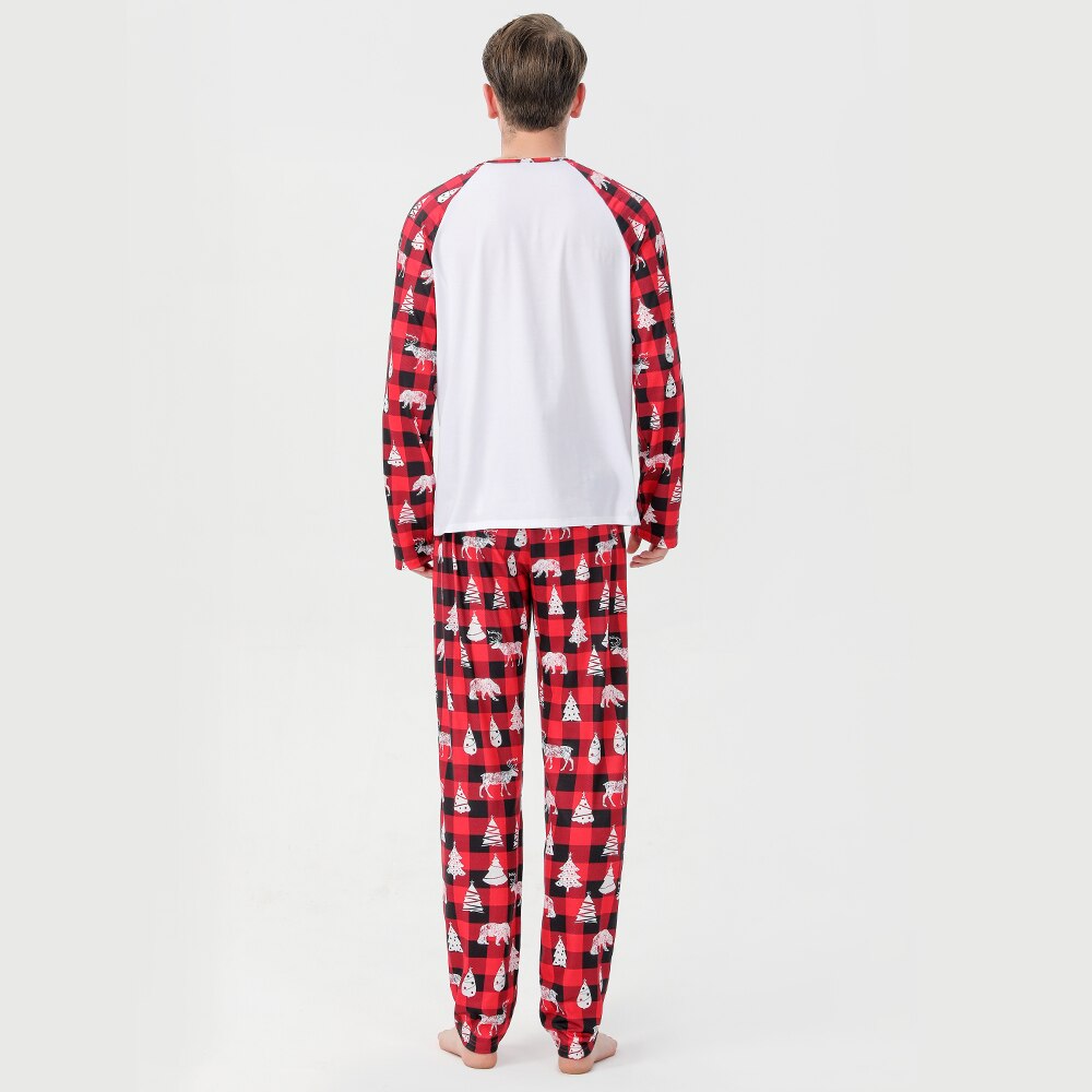 Adult man and woman smiling in matching red and black plaid Christmas pajamas, festive sleepwear set.