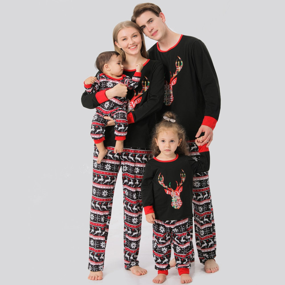 Family in red & black plaid elk Christmas pajamas, smiling, cozy holiday loungewear