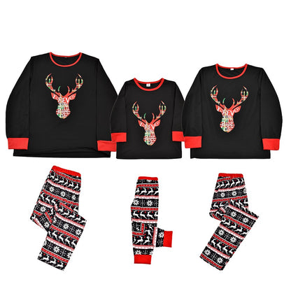 Close-up of baby in 'My 1st Christmas' elk pattern pajama onesie, festive sleepwear