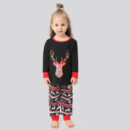 Adult woman wearing red elk print Christmas pajamas, holding hot cocoa, winter festive sleepwear