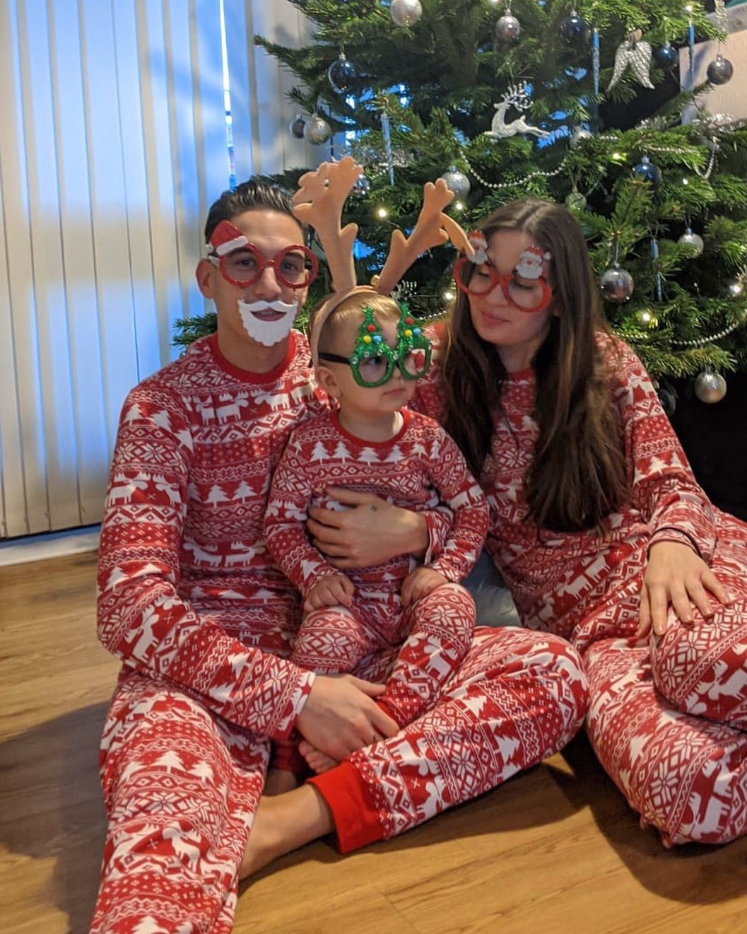 Parents and baby wearing red cotton blend Christmas pajamas, comfortable family matching outfits