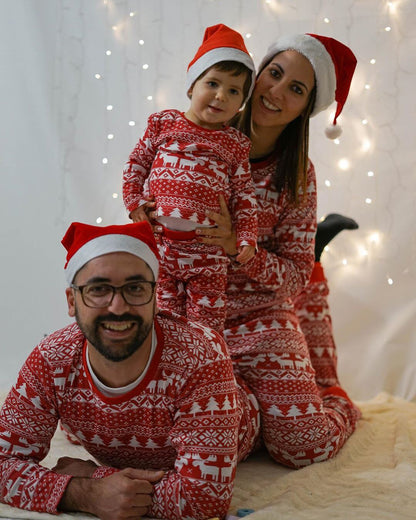 Happy family opening gifts in matching red Christmas pajamas, perfect holiday sleepwear moments