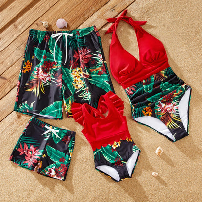 Family in tropical print matching swimsuits and drawstring trunks, perfect for beachwear.