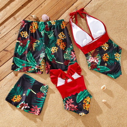 Mom and daughter in halter swimsuits, dad and son in matching floral swim trunks.