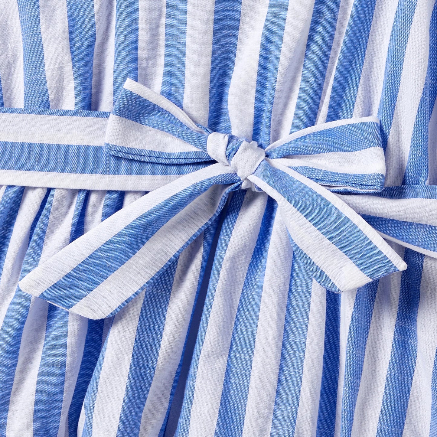 Matching stripe short-sleeve shirts for father and son, with subtle tassel accents.