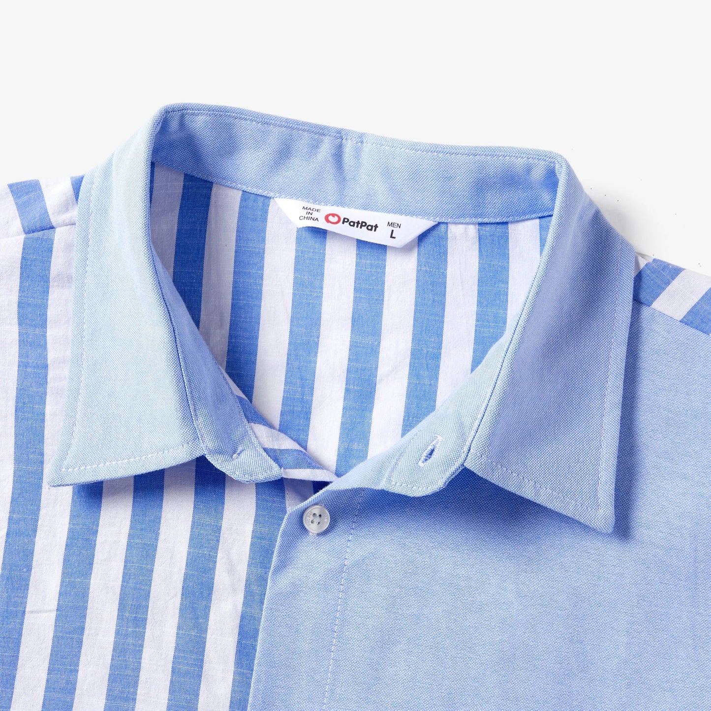 Detail of the tassel trim on the hem of a blue and white stripe family matching dress.