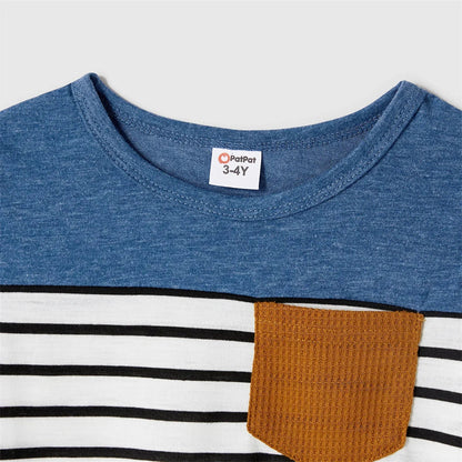 Matching family outfits featuring blue dresses & striped t-shirts, ideal for beach or family gatherings