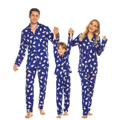 Smiling family wearing matching holiday attire pajamas set, festive sleepwear for Christmas