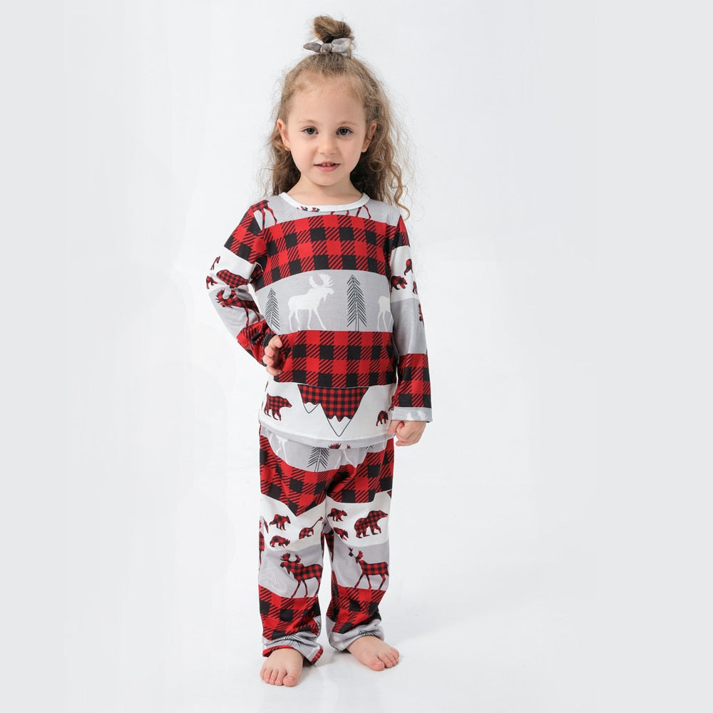Close-up of soft Christmas pajamas fabric, matching set in red and green for family and pet