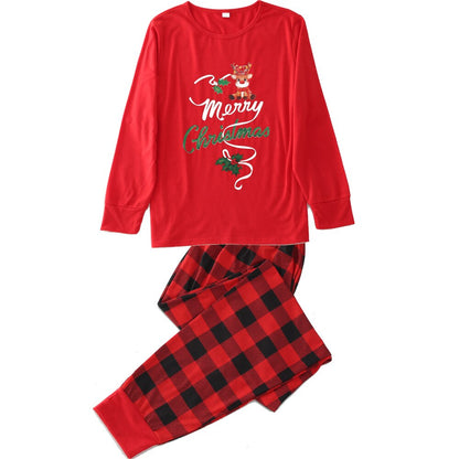 Family loungewear: adult, child, and baby garments from a Christmas pajamas set on a white background