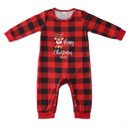 Christmas outfits: a stack of cozy family holiday sleepwear in various sizes, including baby clothes