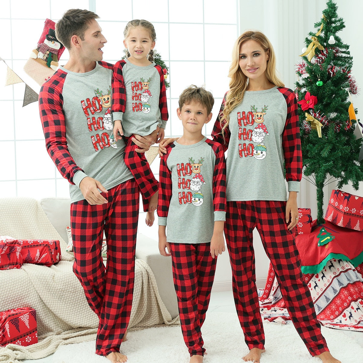 Festive family sleepwear set, red pajamas with amusing Christmas character prints for comfort.