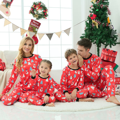 Cute baby in a matching snowman sleepsuit from a family Christmas pajamas set, cozy holiday gift