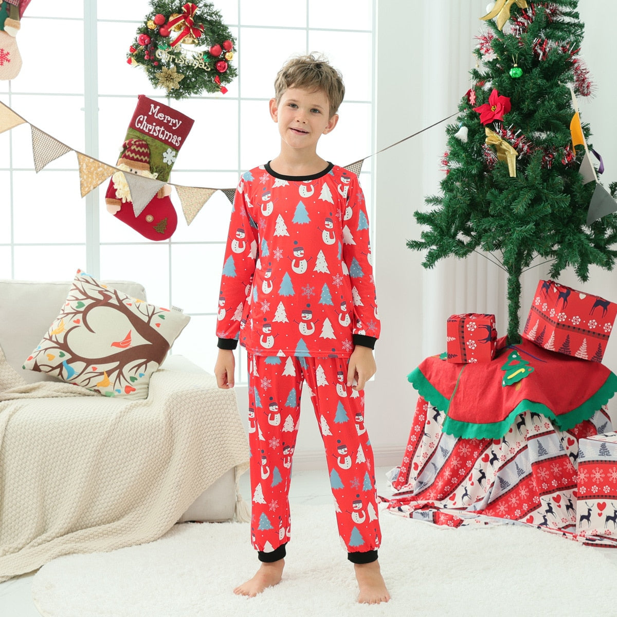 Lay flat of family Christmas snowman pajamas, including adult and kids sizes, warm holiday sleepwear