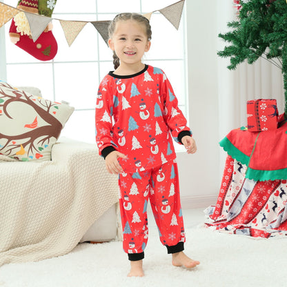 Smiling family in matching snowman Christmas pajamas, enjoying festive moments in comfortable sleepwear