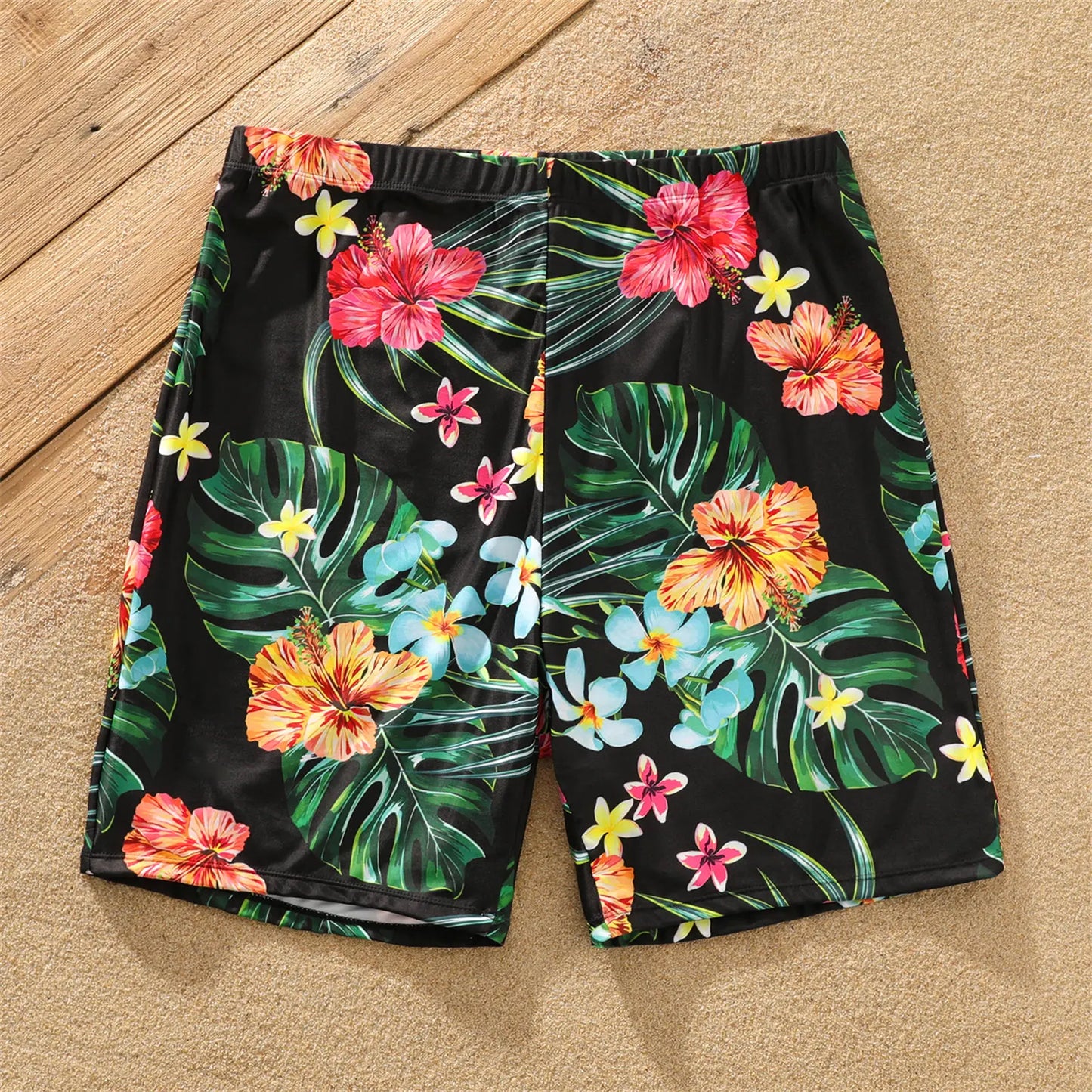 Kids' coconut tree print swimwear, designed for comfort and fun at the beach or pool.