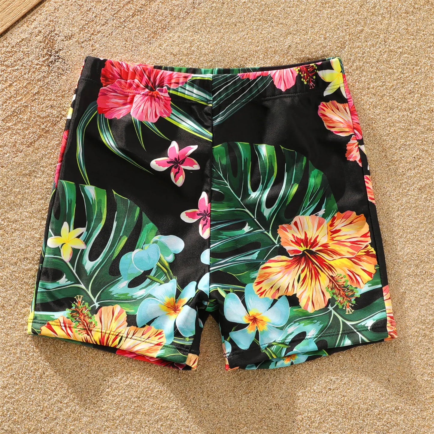 Baby in coconut tree print swimwear, part of a family matching set for summer and beach outings.