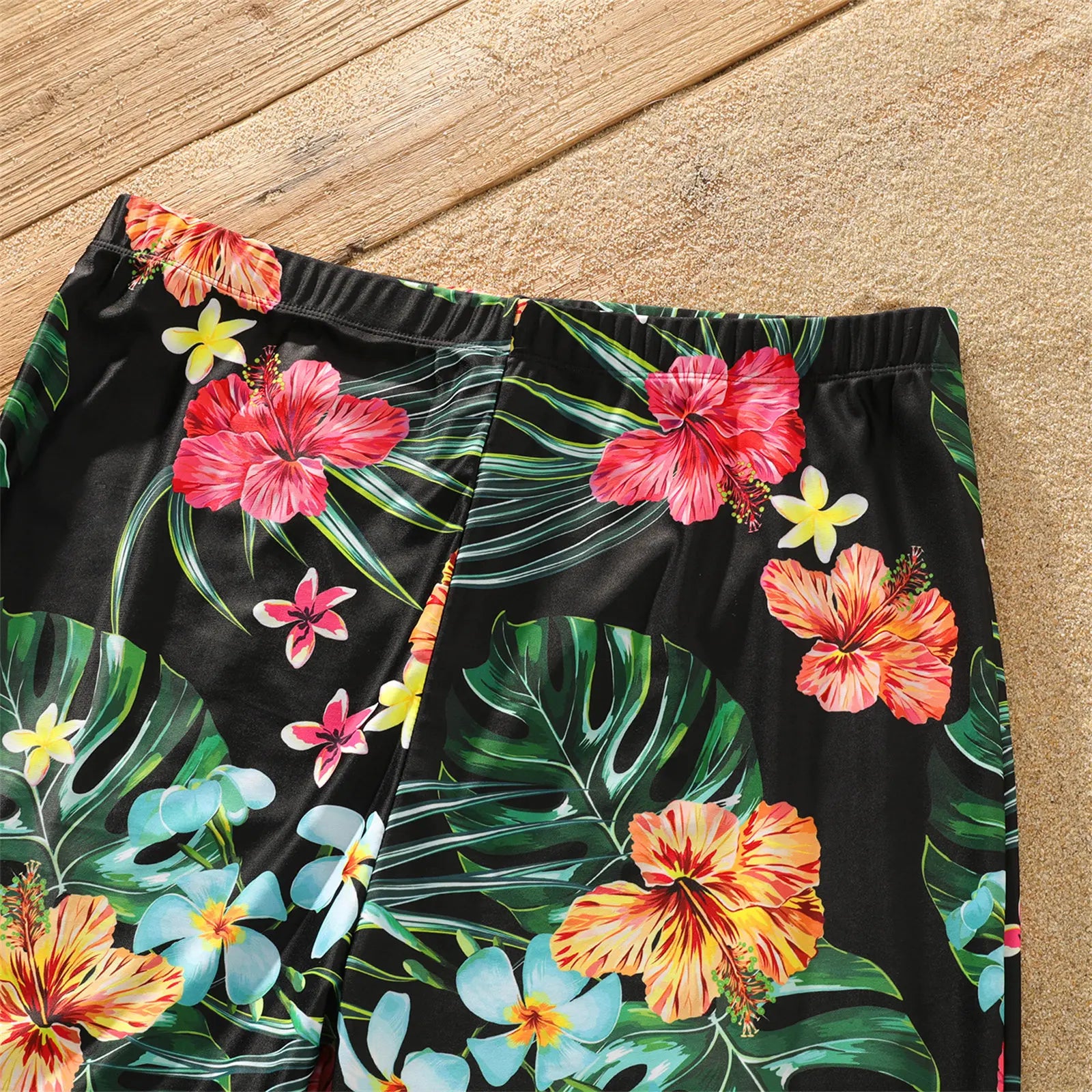 Full set of family matching coconut print swimwear and shorts laid out for summer vacation planning.