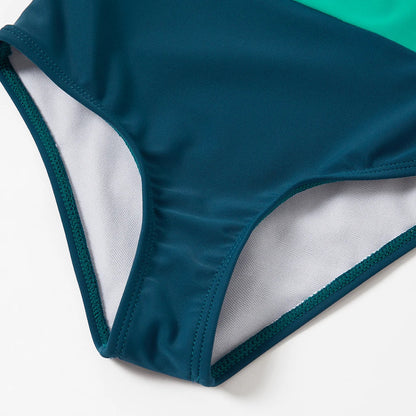Set of folded family color block swimwear, showing various sizes for family members, ready for travel