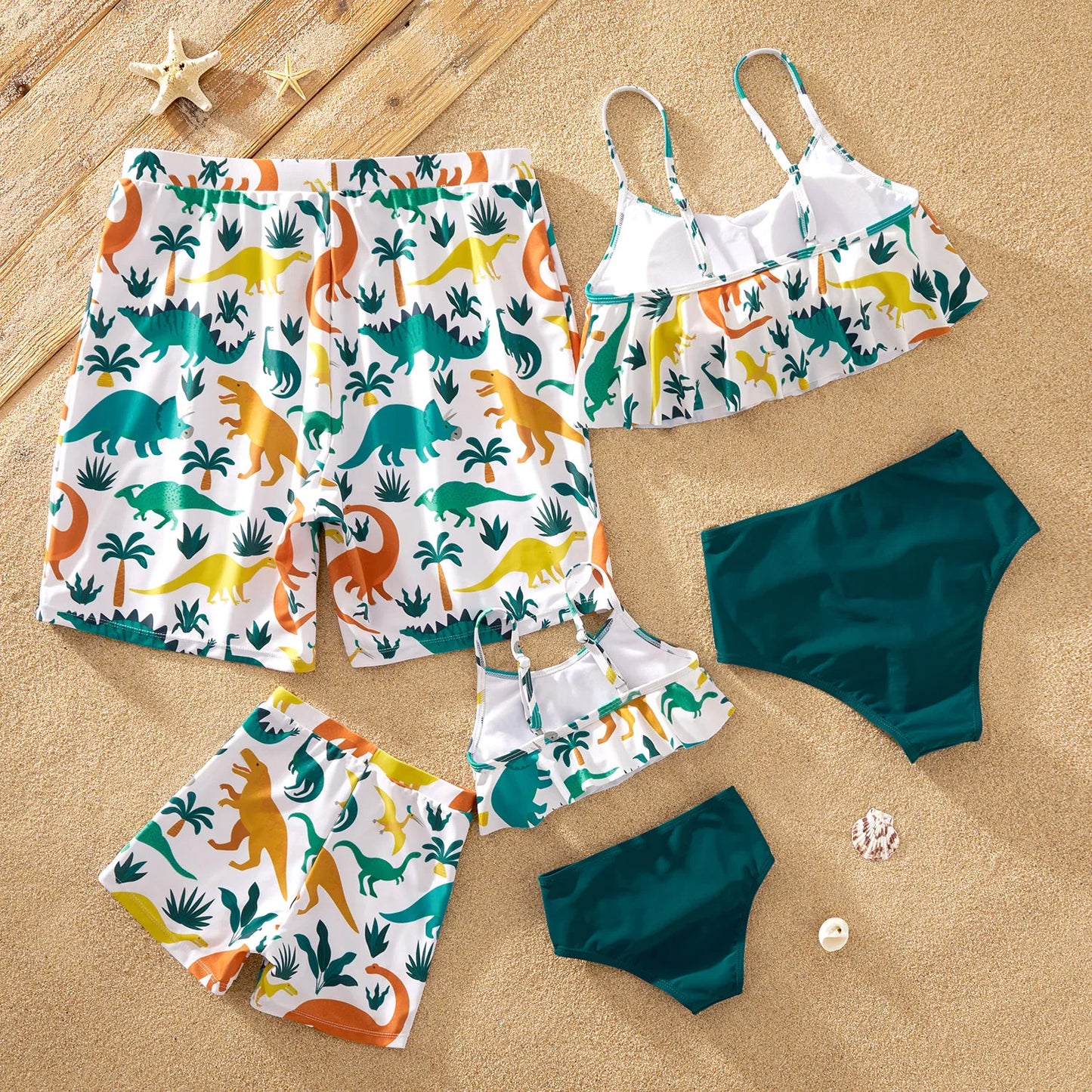 Dad and son matching blue dinosaur print swim trunks for family beach vacation and pool parties.