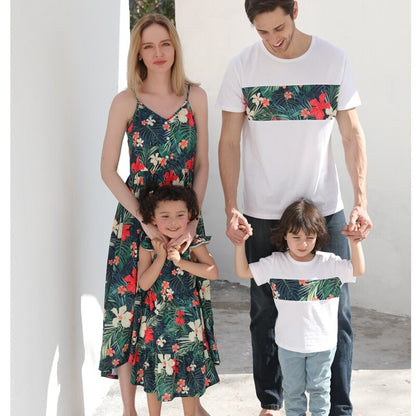 Close-up of a mother and daughter wearing coordinating floral print cotton dresses in summer