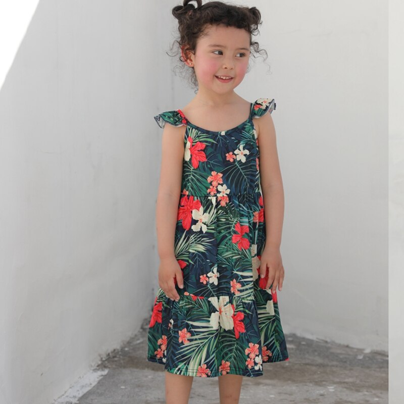 Baby in a cute floral print romper, part of a family matching set, made from soft cotton