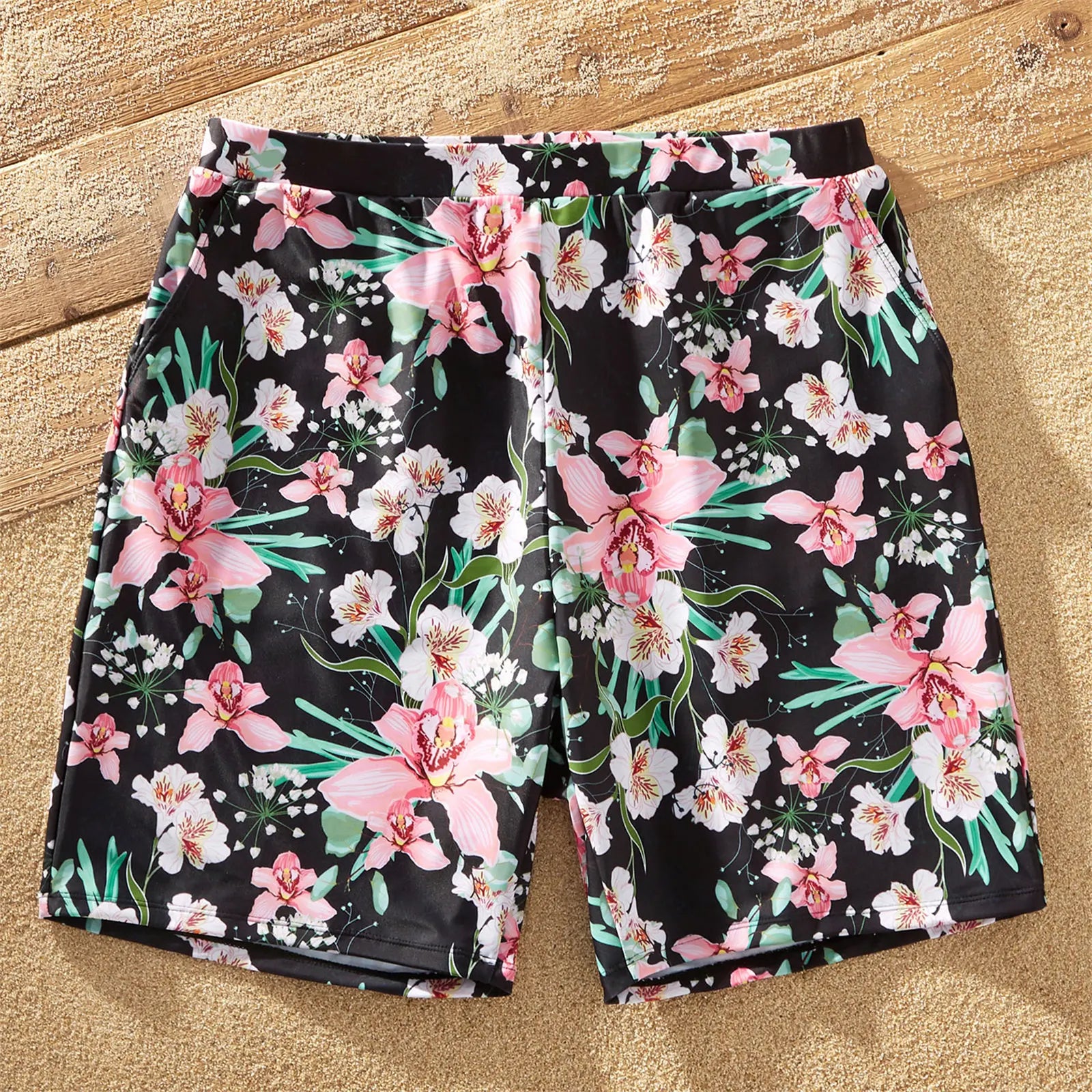 Family enjoying vacation in matching floral swimwear, embodying summer beach life.