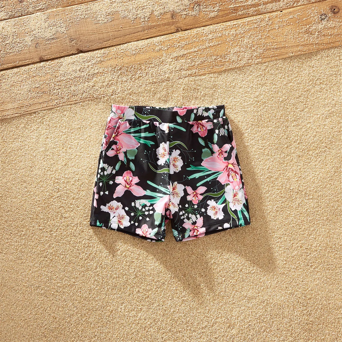 Complete set of family matching floral swimsuits, trunks, and one-piece for summer.