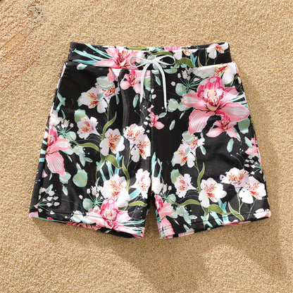 Close-up of vibrant floral print on matching family swimsuits for summer pool attire.