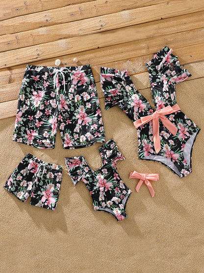 Matching floral swim trunks for a boy, comfortable beachwear for active play.