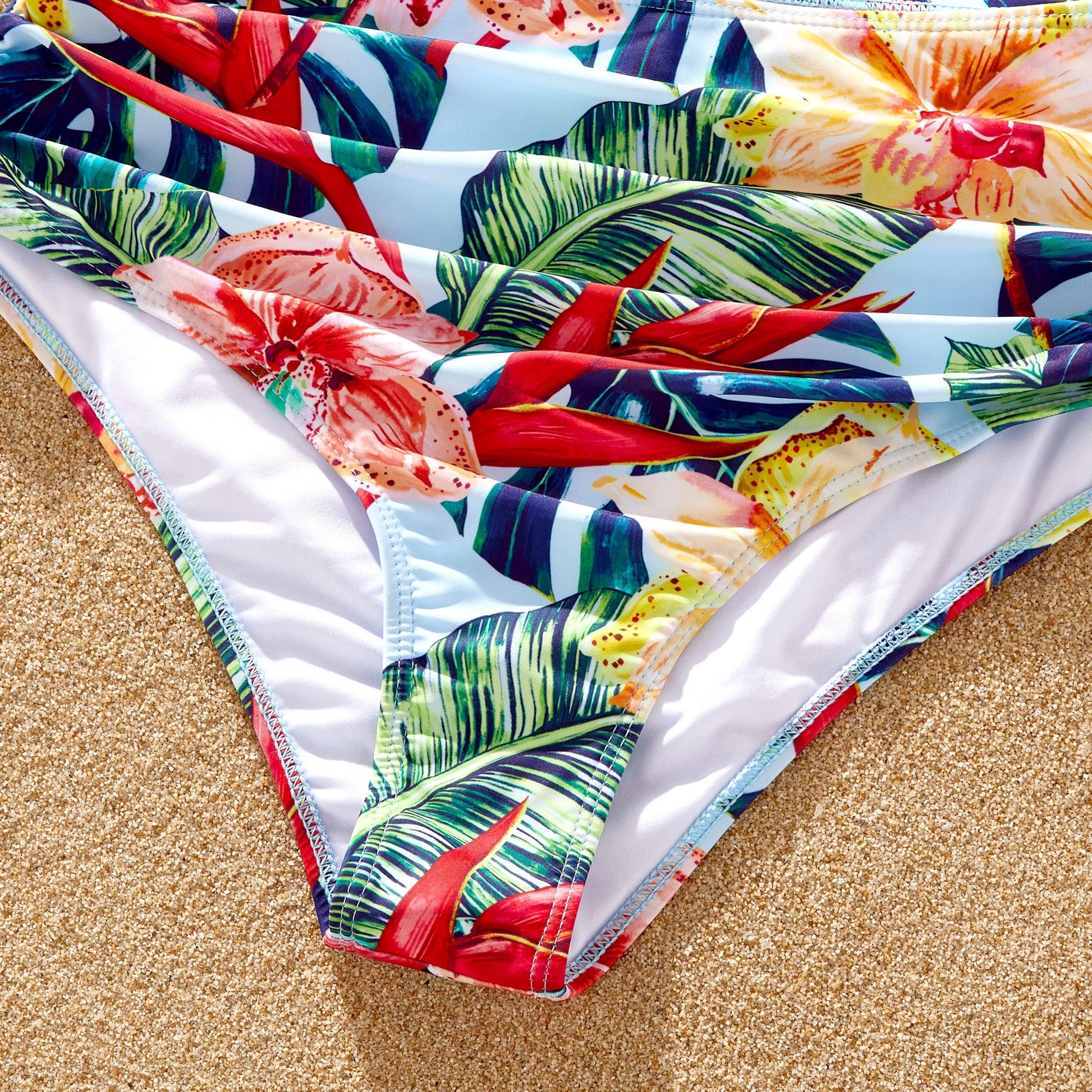 Red floral women's bikini top, stylish and comfortable for beach outing.