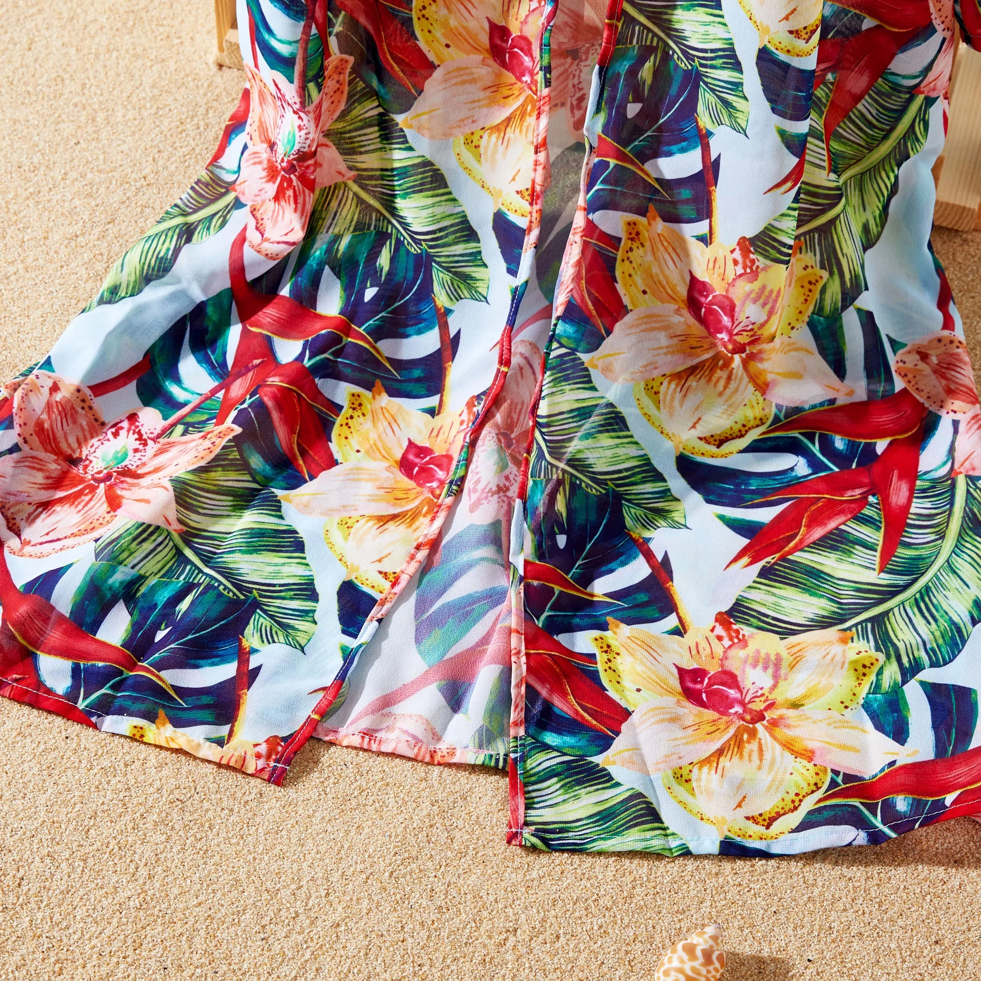 Red floral print beach cover-up for women, elegant and airy vacation outfit.